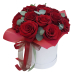Σύνθεση σε στρογγυλό κουτί με κόκκινα τριαντάφυλλα και φύλλα ευκάλυπτου. 